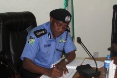 IG of Police Solomon Arase filling the Guest Register