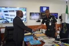 Inspector-General of Police, Mohammed Abubakar Adamu receiving  ICPC Chairman, Prof. Bolaji Owasanoye