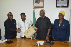 Secretary-to-the-Commission-Dr.-Elvis-Oglafa-presenting-some-IEC-materials-to-Mr.-Akin-Fadeyi-during-the-visit