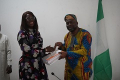 ICPC Chairman Prof. Bolaji Owasanoye, SAN presenting  Chief Operating Officer AACAS, Mrs. Bawo Egbakhumeh with ICPC publications