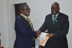 ICPC Chairman, Prof. Bolaji Owasanoye presenting some ICPC publication to the  president of (NIQS), QS Micheal Olayemi Shonubi