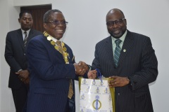 The  president of (NIQS), QS Micheal Olayemi Shonubi presenting some publication to ICPC Chairman, Prof. Bolaji Owasanoye