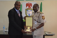 ICPC Acting Chairman, Dr. Musa Usman Abubakar [L], receiving a commemorative plaque from NIS Controller-General, Muhammed Babandede [R], during the courtesy visit
