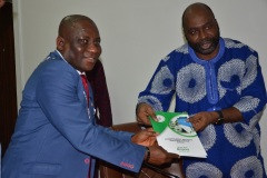 ICPC Chairman, Prof. Bolaji Owasanoye presenting IEC materials to the President and Chairman of  National Institute of Estate Surveyor and Values Emmanuel Okas Wike