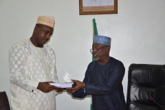 Alh. Bako Abdullahi, the out-gone Acting Chairman handing over to theSecretary to the Commission, Dr Musa Usman Abubakar