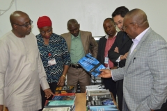 Dr. Elvis Oglafa, Secretary to the Commission, taking a closer look at some of the books presented to ICPC's Academy by UNODC