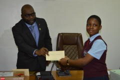 ICPC Chairman  presenting the winner of the National Essay Competition Junior Secondary category Miss. Chikeze Favour, a JSS 2 student  of Mountain Crest School Owerri, Imo State. with her cash prize