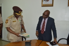 ICPC Chairman, Prof Bolaji Owasanoye discussing with Comptroller-General of Nigeria Immigration Service, Mohammed Babandede